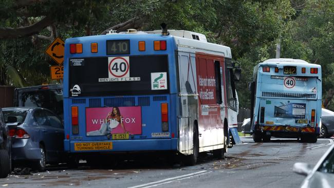 It is understood both buses were heading westbound when one of them hit the bus in front, causing it to crash into three parked cars. Picture: NCA NewsWire/ Jonathan Ng