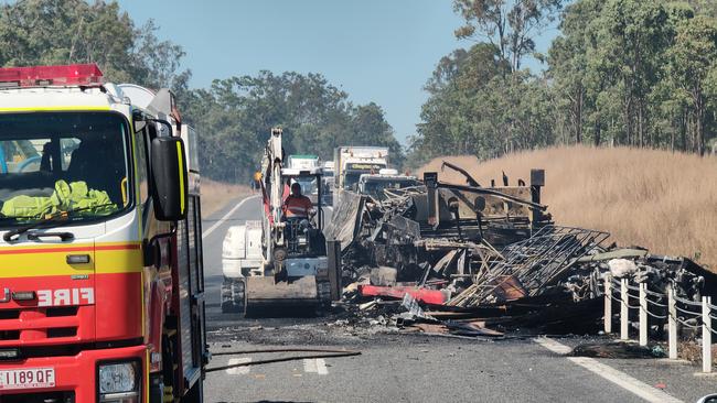 Claytons towing at work clearing the wreckage of a fiery two truck crash on the Bruce Highway, 37km south of Miriam Vale on August 5. Picture: Rodney Stevens