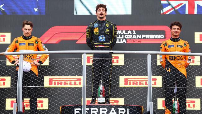 Race winner Charles Leclerc stands above Oscar Piastri and Lando Norris aftert the Italy Grand Prix. Picture: Getty