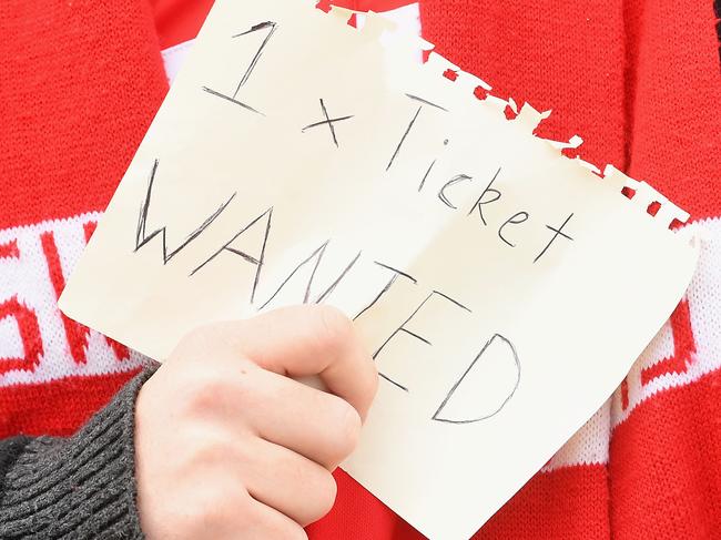 MELBOURNE, AUSTRALIA - OCTOBER 01:  A fan searches for tickets before the 2016 AFL Grand Final match between the Sydney Swans and the Western Bulldogs at Melbourne Cricket Ground on October 1, 2016 in Melbourne, Australia.  (Photo by Quinn Rooney/Getty Images)