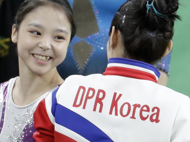 South Korea's Lee Eun-ju, left, talks with North Korea's Hong Un Jong during the artistic gymnastics women's qualification the 2016 Summer Olympics in Rio de Janeiro, Brazil, Sunday, Aug. 7, 2016. (AP Photo/Dmitri Lovetsky)