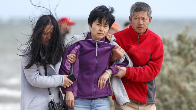 Devastated family and friends gathered on the beach to await news. Picture: David Geraghty