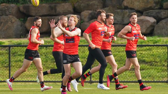 Conor McKenna, Michael Hurley, Cale Hooker, Matt Guelfi train during an AFL Essendon Bombers training session.