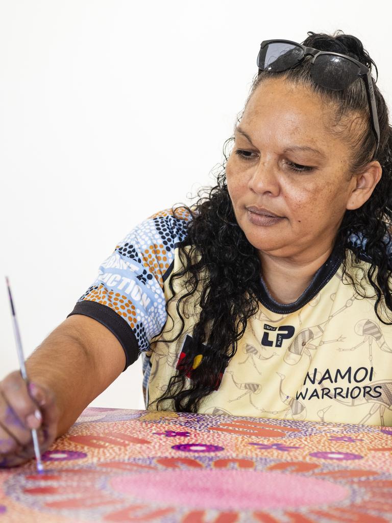 Stacey Trindall of Baru Maranga Art works on a piece of art at her stall at the Indigenous Artisan Markets at The Lighthouse, Saturday, December 17, 2022.