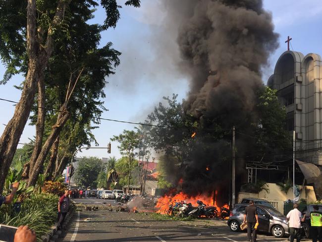 Police at the site of a blast outside the Gereja Pantekosta Pusat Surabaya (Surabaya Centre Pentecostal Church) in Surabaya. A series of blasts, including at least one suicide bombing, struck churches in Indonesia. Picture: AFP