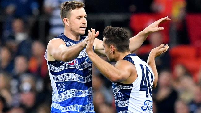 Mitch Duncan and Luke Dahlhaus celebrate a goal for the Cats. Picture: AAP Images