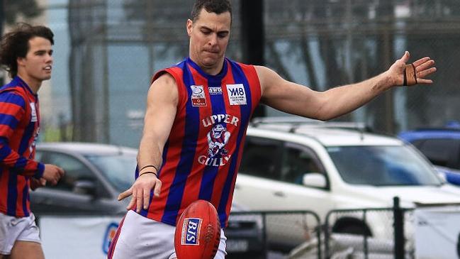 Joel Perry clears the ball from defence for Upper Ferntree Gully. Picture: Davis Harrigan