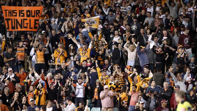 Wests Tigers supporters cheer a try at Leichhardt Oval.