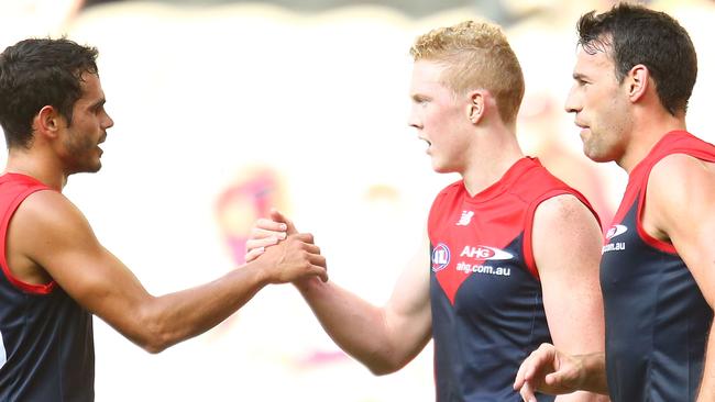 MELBOURNE, AUSTRALIA - MARCH 13: Clayton Oliver of the Demons is congratulated by his teammates after kicking a goal during the NAB Challenge AFL match between the Melbourne Demons and the St Kilda Saints at Etihad Stadium on March 13, 2016 in Melbourne, Australia. (Photo by Scott Barbour/Getty Images)