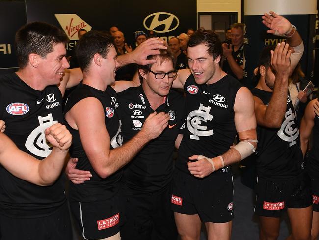 Coach of the Blues David Teague (centre) sings the club song with players after the Round 12 AFL match between the Carlton Blues and the Brisbane Lions at Marvel Satdium in Melbourne, Saturday, June 8, 2019. (AAP Image/Julian Smith) NO ARCHIVING, EDITORIAL USE ONLY