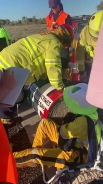 Firefighters work to remove pro-Palestinian protesters from a concrete barrel