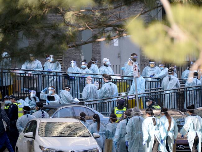 Healthcare workers prepare to enter the North Melbourne tower. Picture: Andrew Henshaw