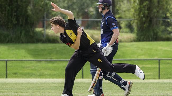 Premier: Richmond’s Mitch Perry rolls the arm over in front of Prahran’s Nick Blaich. Picture: Valeriu Campan