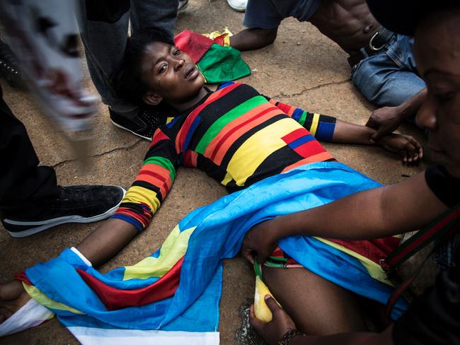 A Congolese protester lies on the ground after police opened fire with rubber bullets in Pretoria, South Africa. Picture: AFP/John Wessels