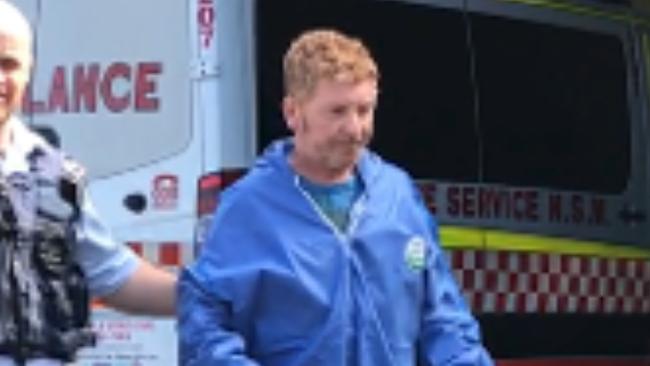 Neil Hutchison, 52, of Mardi, being led out of Wyong Hospital after he ploughed into three shoppers at Westfield Tuggerah. Picture: supplied.