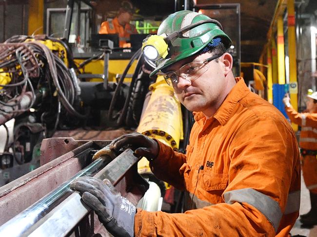 FILE - BHP worker is seen during a tour of the Olympic Dam mine site in Roxby Downs South Australia, Friday, August 30, 2019. BHP officially launched its Underground School of Excellence at Olympic Dam, for people without experience in mining. AAP Image/David Mariuz) NO ARCHIVING.