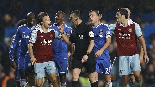 Chelsea's and West Ham's players question referee Neil Swarbrick.