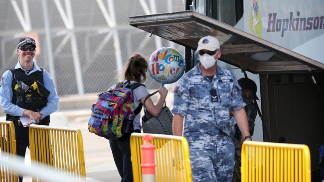 Flight passengers at Sydney airport are escorted to a bus for transportation to mandatory hotel quarantine. SYDNEY, AUSTRALIA - NewsWire Photos. November 28, 2020. Picture: NCA NewsWire / Dylan Coker