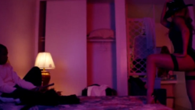 Red light ... Beyonce dons suspenders in this sexy scene from the couple’s tour trailer.