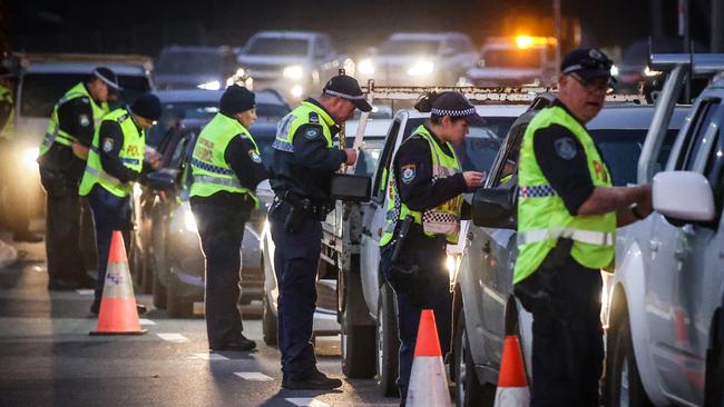 Police stop and question drivers at a checkpoint on the NSW-Victoria border in 2020, amid covid lockdowns. Picture: Getty