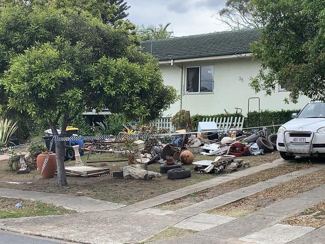 A mountain of miscellaneous items – including Rusted tools, styrofoam boxes and an old washing machine – has piled up in front of the Enright house. Picture: Supplied