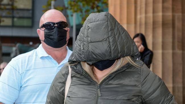 Lina Costanzo leaves the Adelaide Magistrates Court with a supporter. She is yet to enter pleas to three counts of persistent sexual exploitation of a child. Picture: NCA NewsWire / Brenton Edwards