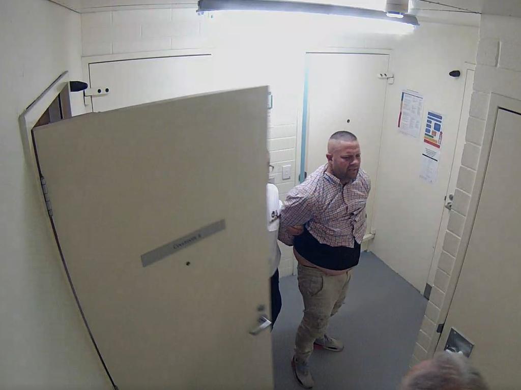 After the scuffle in September 2020, Nicholson was escorted away by officers. Picture: Courts SA