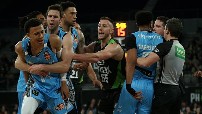 An incensed RJ Hampton of New Zealand (left) is restrained by teammate Tom Abercrombie in an incident that led to him being ejected against the Phoenix on Saturday. Picture: AAP