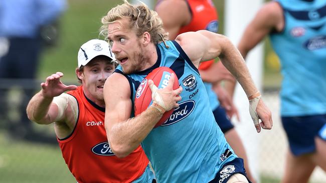 Cats training at Deakin Uni. Cam Guthrie escapes Jed Bews. Picture Jay Town.