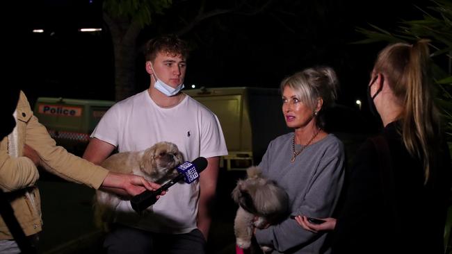 Beau Broomfield and Gayle Burgess talk with media outside the Newport Apartments at Hamilton, following the discovery of a body. Picture: David Clark