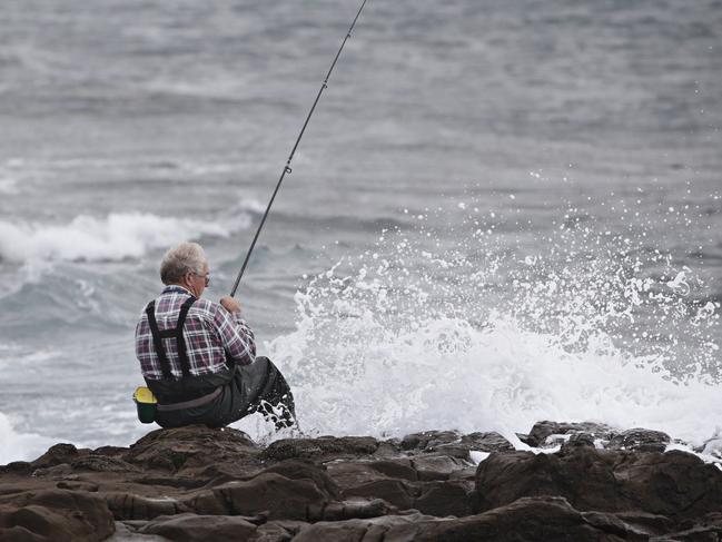 Gary Cuzner who has been fishing at Hill 60 Near Fishermans Beach for over 50 years on an area he considers to be safe at Hill 60 on the 13th of February. Two men are dead after being swept off rocks at Port Kembla's Hill 60 Near Fishermans Beach. Picture: Adam Yip