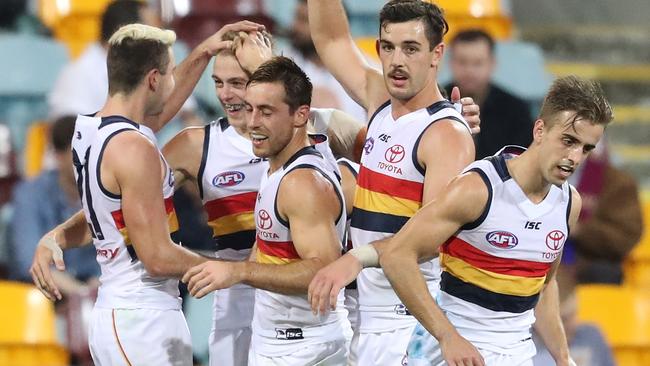 Hugh Greenwood celebrates a goal with Adelaide teammates.