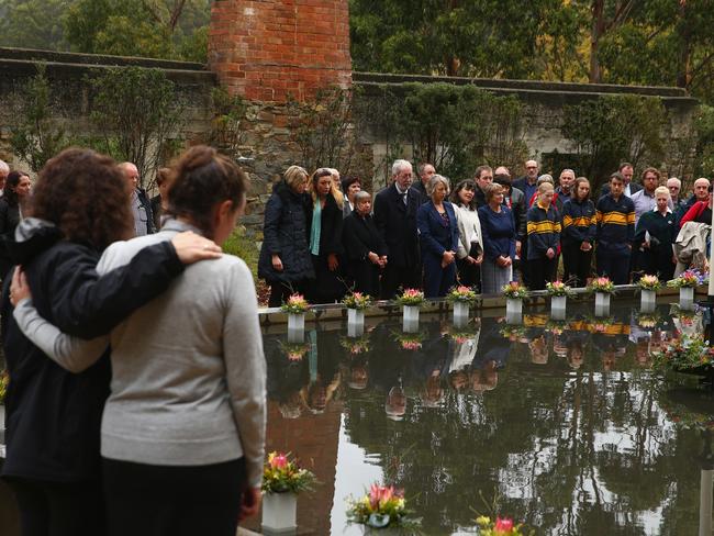 Family and community members lay 35 floral tributes in the Memorial Pool to remember the victims. Picture: GETTY