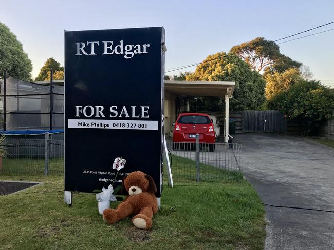 A teddy bear is left outside the home by a local.