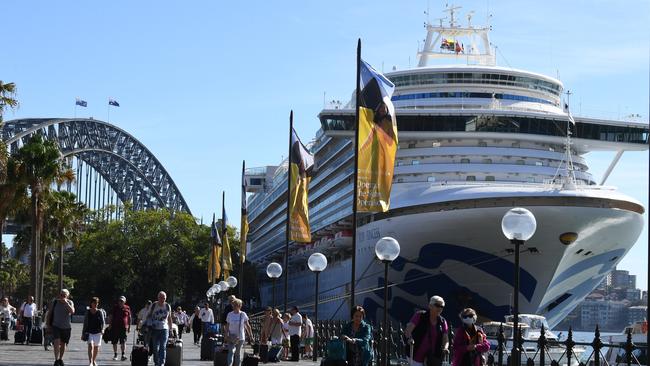 Cruise ship passengers disembark from the Princess Cruises owned Ruby Princess at Circular Quay in Sydney, Thursday, March 19, 2020. (AAP Image/Dean Lewins) NO ARCHIVING