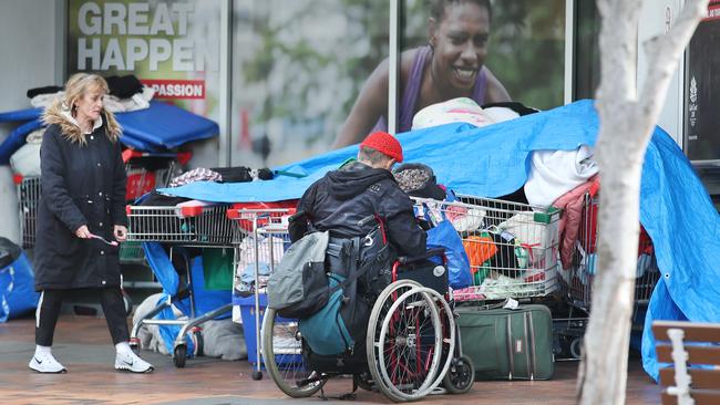 Homeless store their belongings under a giant tarp outside the entrance to Southport TAFE in the middle of town at Nerang Street, Southport. Picture Glenn Hampson.