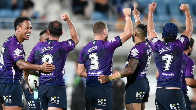 Cameron Smith of the Storm (9) and teammates gesture to the coaching box after Smith scores a try. Picture: Matt Roberts/Getty Images