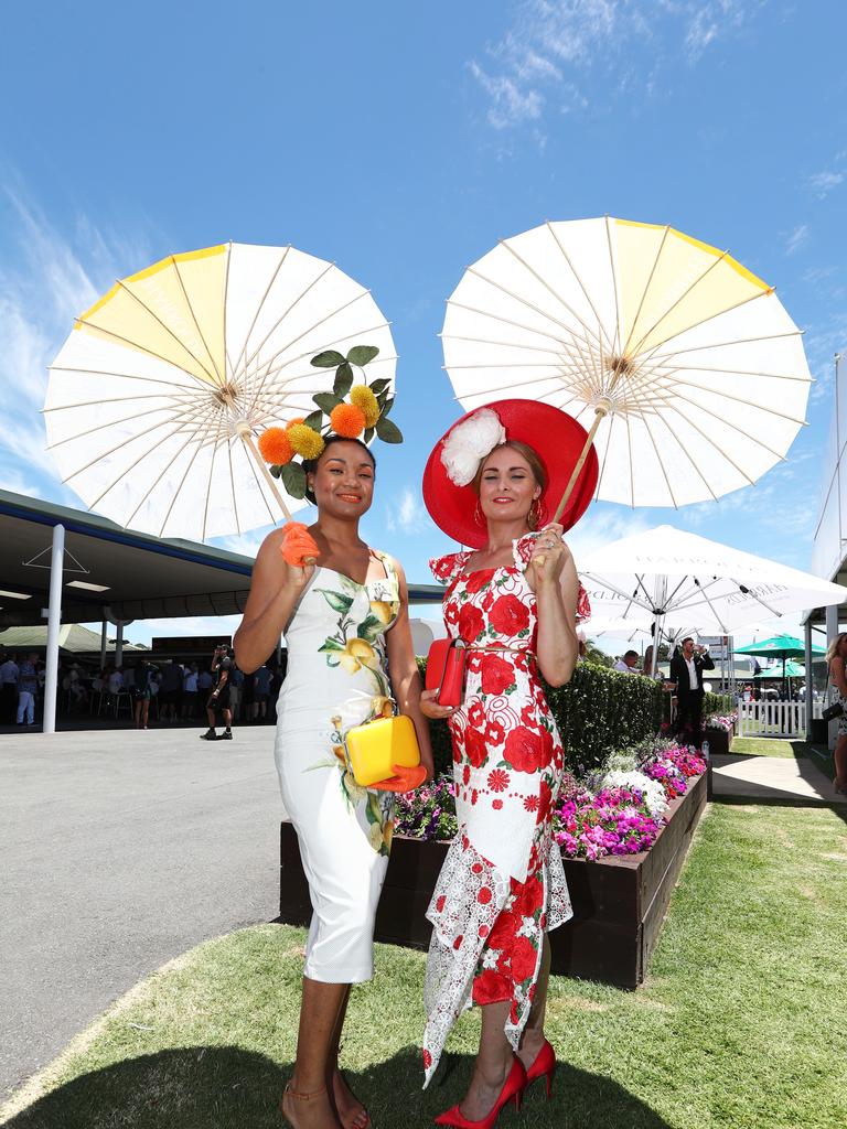 Rai Jones and Anita Marshall showing off their outfits at the Magic Millions race. Photo: Jason O'Brien