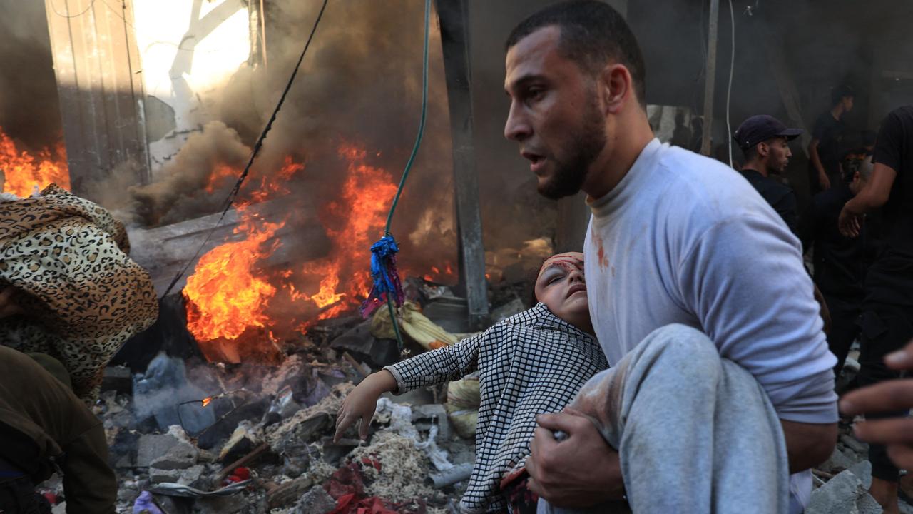 A man evacuates a wounded girl after Israeli bombardment in Rafah in the southern Gaza Strip. Picture: AFP