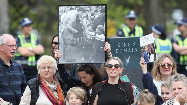 A woman holds aloft a picture of Prince Charles. Picture: AAP