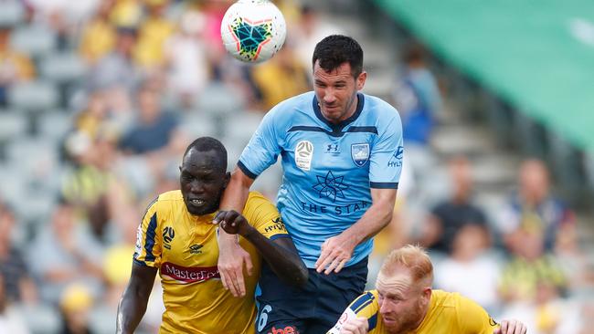 Ryan McGowan heads a ball from Mariners defenders during round 20.