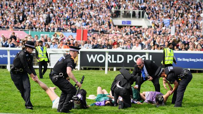 Animal rebellion activists arrested after running onto the racecourse, on day two of the Epsom Derby. Picture: Getty Images.