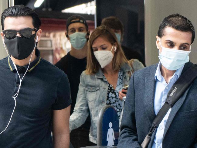 (FILES) In this file photo taken on June 15, 2020 Commuters wearing face masks walk through the ticket barriers at Waterloo Station in London on June 15, 2020 after new rules make wearing face coverings on public transport compulsory while the UK further eases its coronavirus lockdown. - The number of workers on UK company payrolls slumped last month on Britain's coronavirus lockdown, official data showed July 16, 2020, sparking calls for more government action to protect jobs. The latest grim data came after news that the UK economy slumped almost one-fifth during lockdown --  and faces the prospect of its sharpest annual decline for 300 years as a result of COVID-19. (Photo by Niklas HALLE'N / AFP)