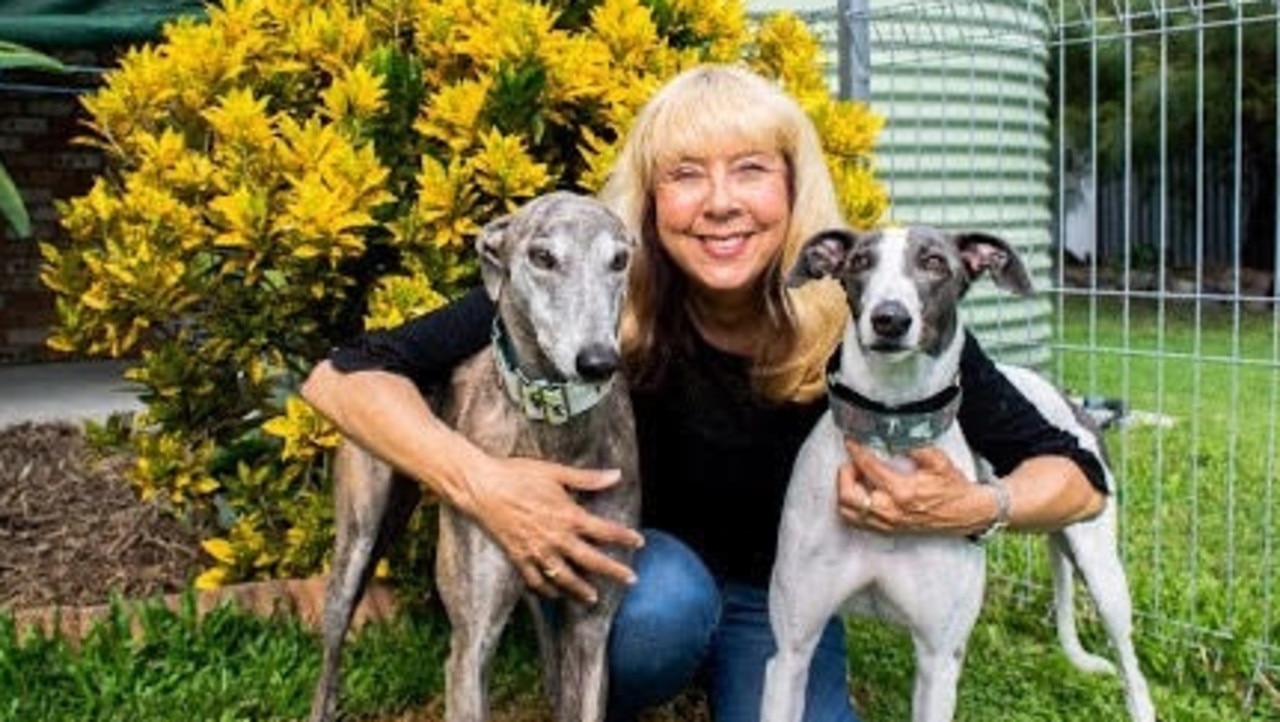 Annie Hendley with two rescue greyhounds. Ms Hendley is calling for change in the industry.