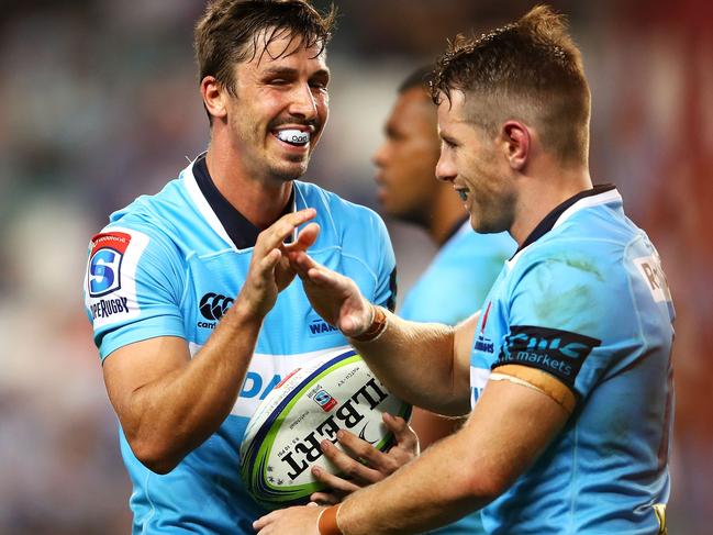 SYDNEY, NEW SOUTH WALES - FEBRUARY 24:  Jake Gordon and Bernard Foley of the Waratahs high five during the round two Super Rugby match between the Waratahs and the Stormers at Allianz Stadium on February 24, 2018 in Sydney, Australia.  (Photo by Mark Kolbe/Getty Images)