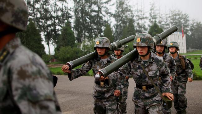 BEIJING - JULY 28:  People's Liberation Army (PLA) soldiers take part in a drill during a reporting trip to the Third Guard Division of the PLA on July 28, 2009 in Beijing, China. August 1st marks the 82nd anniversary of the founding of the PLA. (Photo by Feng Li/Getty Images)