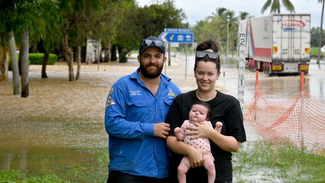 Sunday February 9. Heavy rain causes flooding in North Queensland. Flooding at Plantation Creek in Ayr cuts Bruce Highway to traffic apart from trucks. Ayr couple Aaron and Shannon Benato with thre-month-old Myla. Picture: Evan Morgan