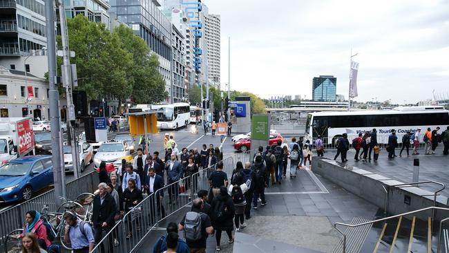 Afternoon peak hour commuters getting replacement buses at Federation Square. Picture: Andrew Tauber.