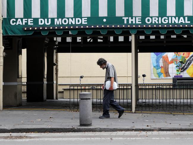 A man walks past a closed Cafe Du Monde in the French Quarter of New Orleans. Picture: AP