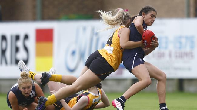 Stella Huxtable is tackled by Stingrays’ Felicity Crank.